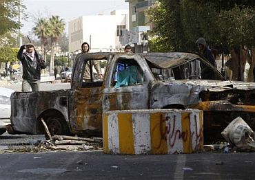 A Libyan gunman opposed to leader Muammar Gaddafi mans a roadblock in the city of Zawiyah