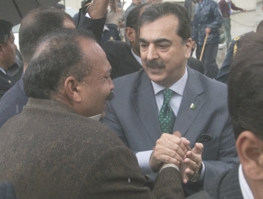 Pakistan's Prime Minister Yusuf Raza Gilani consoles relatives of slain Shahbaz Bhatti