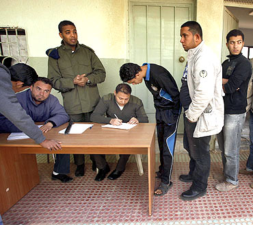 Civilians who have volunteered to join the rebel army register their names in a school in Benghazi