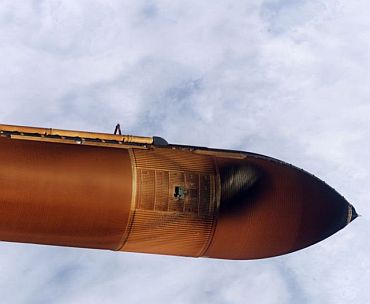 Handheld still image taken by Discovery's crew of the external fuel tank as it was jettisoned after launch were transmitted to the ground early July 27. Initial analysis of the imagery shows a large piece of foam that separated from the tank during the Shuttle's ascent to orbit. The foam detached from an area of the tank called the Protuberance Air Load (PAL) Ramp. In this still image, the area of missing foam on the tank is indicated by a light white spot in near the upper edge of the tank just below the liquid oxygen feedline