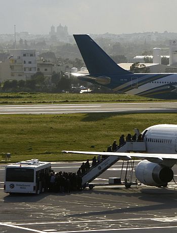 Passengers board a flight out of Tripoli