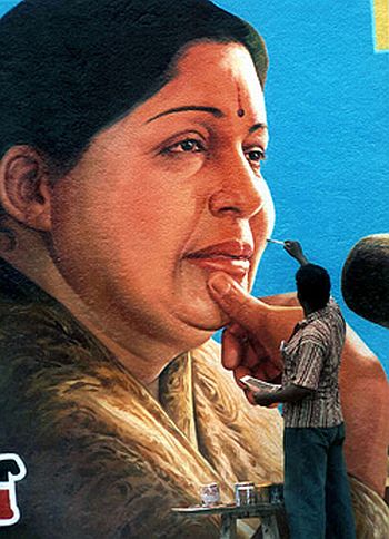 A party worker gives finishing touches to a wall painting of J Jayalalitha