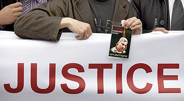 A man holds a photograph of US national Raymond Davis during a rally in Islamabad