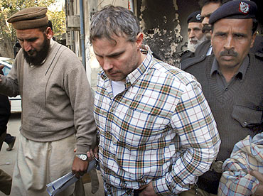 Davis is escorted by police officials near a Lahore court