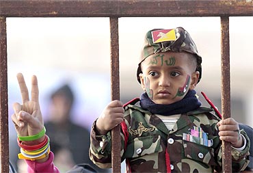 A boy attends a protest against Muammar Gaddafi in Benghazi