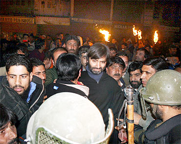 Security personnel detain Yasin Malik with other JKLF activists in Srinagar on Friday