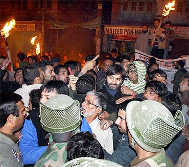 Security personnel detain Yasin Malik with other JKLF activists in Srinagar on Friday.