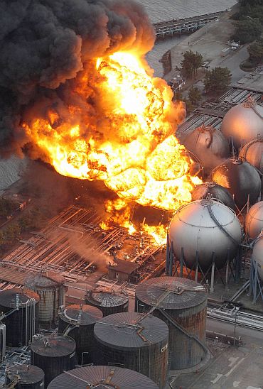 Natural gas storage tanks burn at a facility in Chiba Prefecture