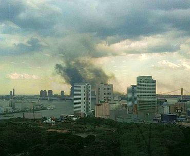 A plume of smoke rises over Tokyo