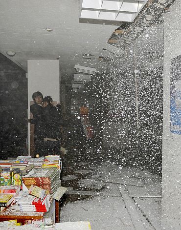 People take shelter as a ceiling collapses in a bookstore