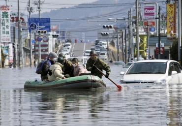 Japan Self Defence Forces troops rescue people from flooded areas in Ishimaki City