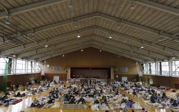 Evacuees, who fled from the vicinity of Fukushima nuclear power plant, rest at an evacuation center set in a gymnasium in Kawamata, Fukushima Prefecture in northern Japan