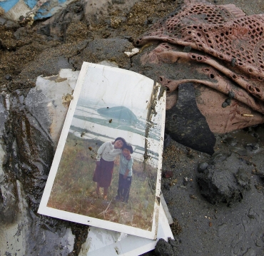 A photograph is seen among rubble in Higashimatsushima City, Miyagi Prefecture in northern Japan