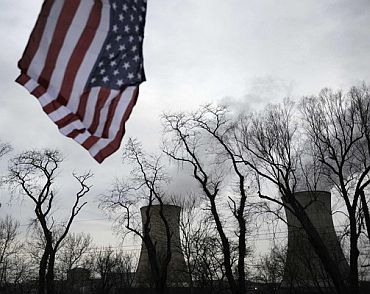 A US flag flies near the cooling towers of the Three Mile Island nuclear power plant in Pennsylvania