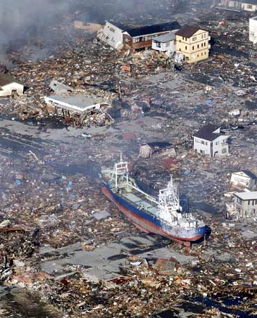 A ship tossed up onto city streets by a tsunami after the earthquake is pictured in Kesennuma City