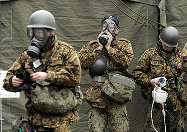 Japan Self-Defense Force officers prepare for a clean-up at a radiation affected area in Nihonmatsu, Fukushima