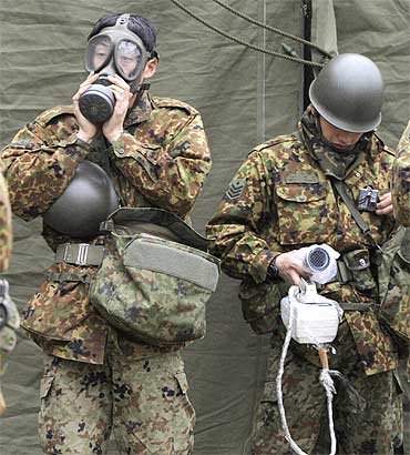 Japan Self-Defense Force officers prepare for a clean-up at a radiation affected area in Nihonmatsu