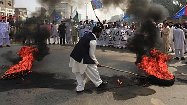 Angry Pakistanis burn tyres in Peshawar while demonstrating against the release of Davis