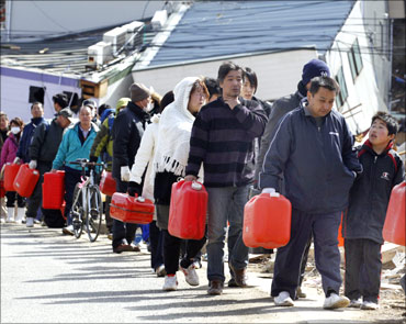 People queue up to buy gasoline at a village destroyed by the earthquake and tsunami in Ofunato, Iwate Prefecture