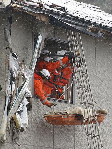 Firefighters in a village destroyed by the earthquake and tsunami in Kamaishi, Japan