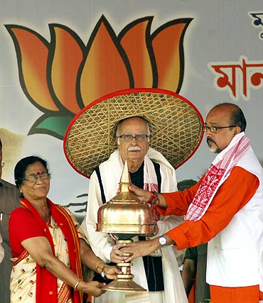 Senior BJP leader Lal Krishna Advani is felicitated by former Assam state BJP president Ramen Deka and BJP leader Bijoya Chakraborty during a public meeting in Guwahati