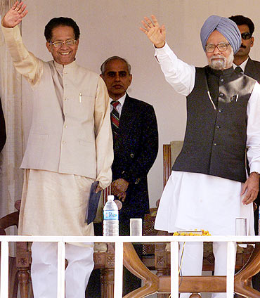 Prime minister Manmohan Singh waves to the crowd along with CM Tarun Gogoi during a function in Dispur