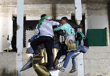 Supporters of Libya's leader Muammar Gaddafi form a human shield at his fortified compound in Tripoli on Saturday