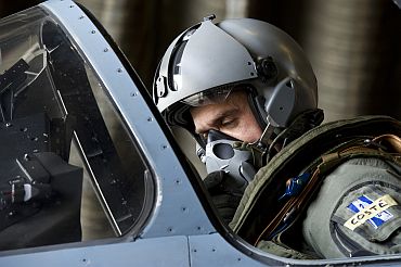 Pilot sits in Mirage aircraft cockpit before mission to overfly Libyan airspace in Dijon military base