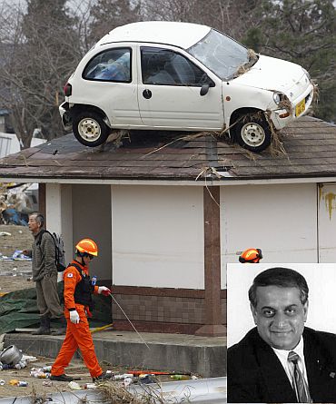 A car is seen on the rooftop of a house as a rescue worker walks past it in an area hit by an earthquake and tsunami in Sendai. (Inset) Parmesh Bhatt