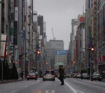 Pedestrians cross a street in Tokyo's Ginza shopping district