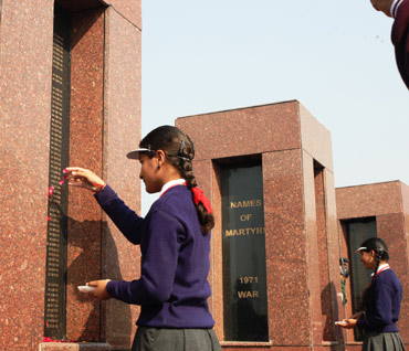 A schoolgirl pays tribute at the memorial