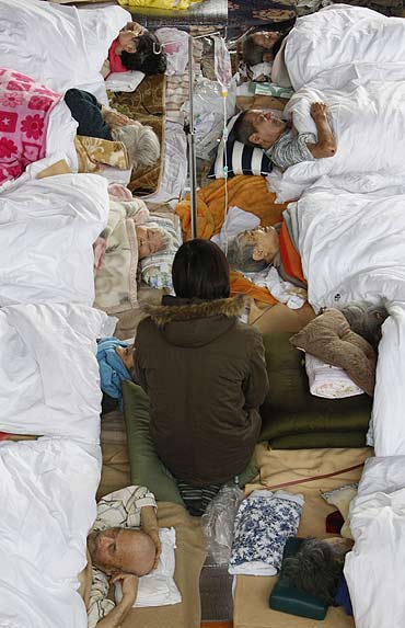 Elderly Japanese people receive medical treatment at an evacuation shelter in Kesennuma, Miyagi Pref