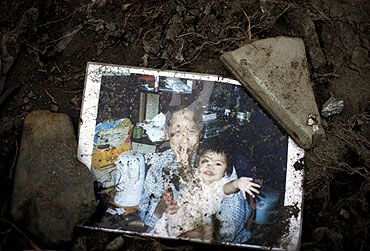 A family picture is seen at the remains of a house after the earthquake and tsunami in Minamisanriku