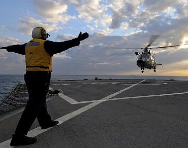 A French navy AS365 F Dauphin rescue helicopter from French aircraft carrier Charles de Gaulle test lands aboard the amphibious command ship USS Mount Whitney. Charles de Gaulle is operating in the Mediterranean Sea supporting the coalition led operations in response to the crisis in Libya
