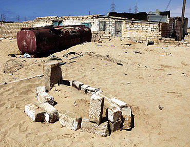 A makeshift grave lies near the front line outside Ajdabiyah