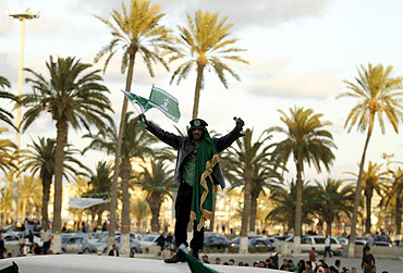 A supporter of Libya's leader Muammar Gaddafi chants slogans during a daily protest at Green Square