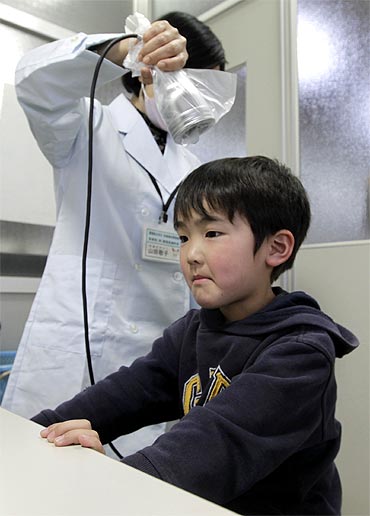 Yuya Sato, from Soma in Fukushima, undergoes a screening test for signs of nuclear radiation