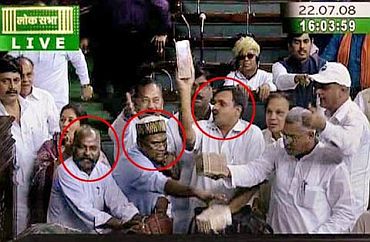 Video grab shows Opposition MPs waving currency notes in the Lok Sabha during the 2008 trust vote