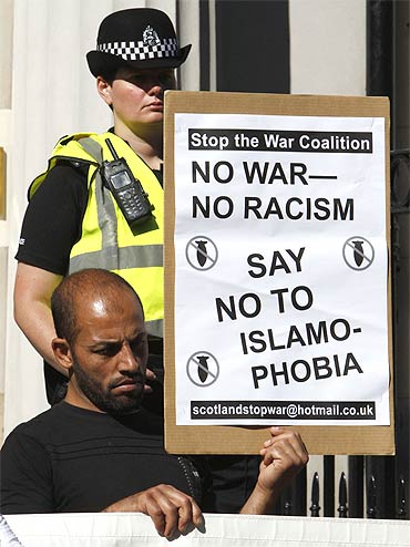 A protester from the Scottish Afghan Society stands outside the US consulate in Edinburgh