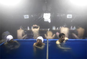 People whose homes were destroyed by the tsunami take a bath in a tent set up by Japan's Self Defense Force in Kamaishi
