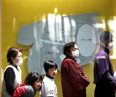 Evacuees wait for food to be distributed at a shelter in Kesennuma, Miyagi Prefecture