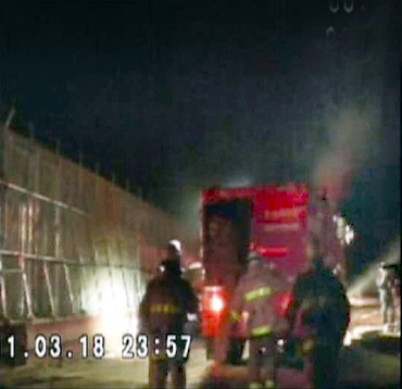 Firefighters wearing respirators work at the Fukushima nuclear plant