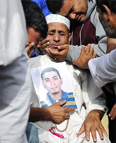 The father of activist Ahmed Farhan is comforted in Sitra. Ahmed was killed during clashes with cops