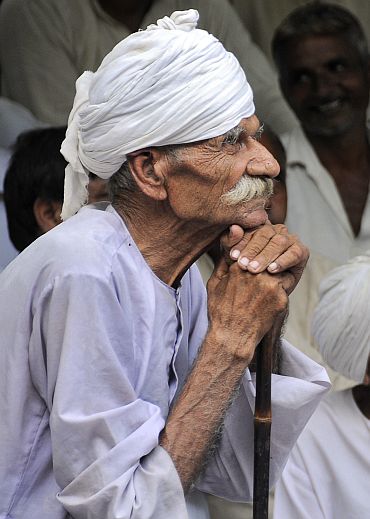 A member of the Jat community listen to a speech during a protest in New Delhi