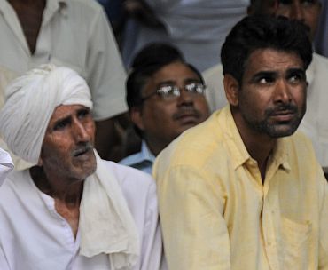 Members of the Jat community listen to a speech