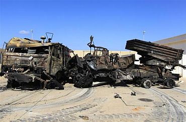 Destroyed military vehicles are seen at a naval military facility after coalition air strikes in People's Port in eastern Tripoli