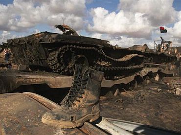 A boot belonging to a soldier loyal to Libyan leader Muammar Gaddafi is seen on a destroyed tank after an air strike by coalition forces, along a road between Benghazi and Ajdabiya