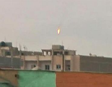 A fighter jet bursts into flames after being shot down over the rebel-held Libyan city of Benghazi