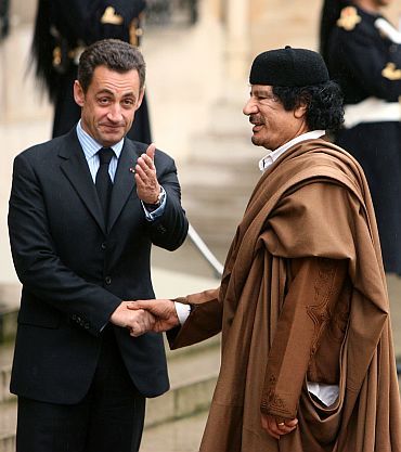 French President Nicolas Sarkozy greet Gaddafi at the Elysee Palace, December 10, 2007
