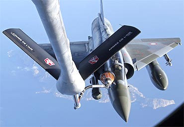 A French Mirage 2000 fighter jet refuels with an airborne Boeing C135 refuelling tanker aircraft. France continues it military air sorties over Libya with NATO indicating the no fly zone operation could last three months